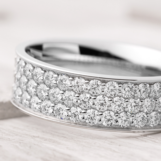 7 mm wide/Flat/10K White Gold band with a 3 Row Eternity arrangement of .03 carat Round Diamond (ST) stones in a Bead Channel setting.