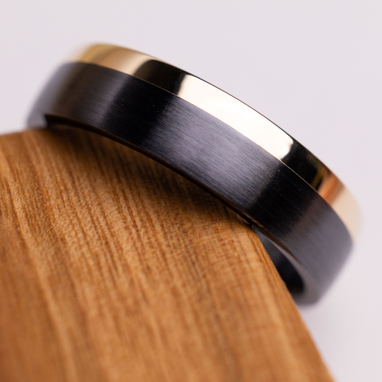 6 mm wide/Domed/Zirconium band with one 2 mm Off Center Edge inlay of 14K Yellow Gold.